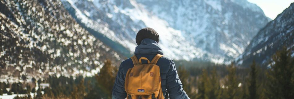 Randonneur en balade hivernale dans le Queyras avec sac à dos et montagnes enneigées